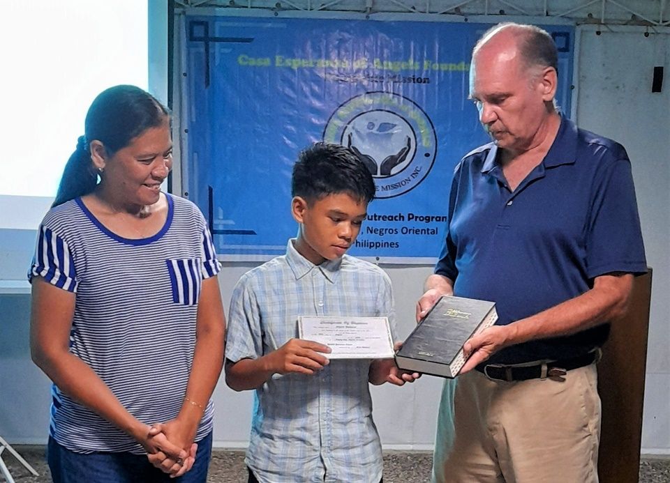 Angelo receiving personal Bible