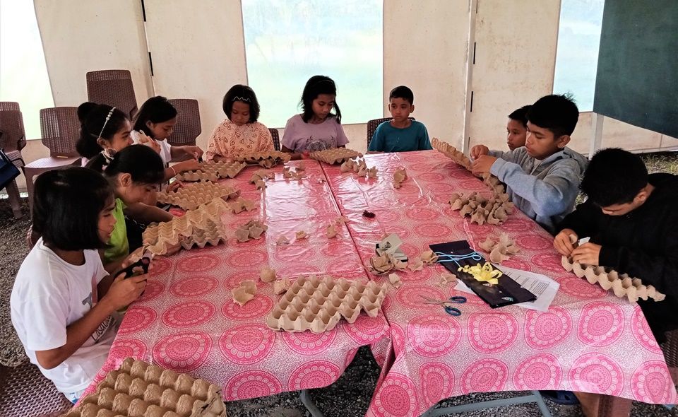 CEA children making decors from egg trays