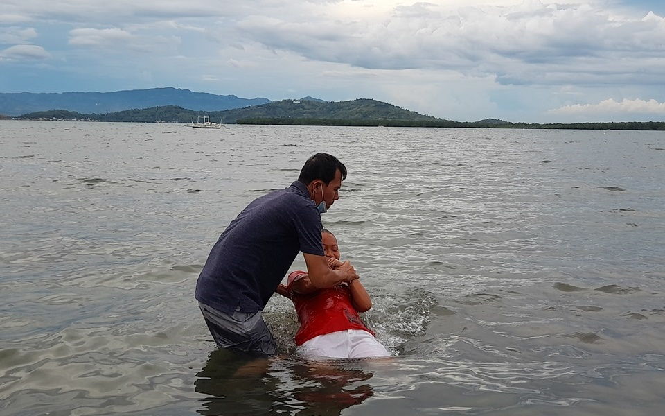 Dennis Bello supervising baptism rites 2