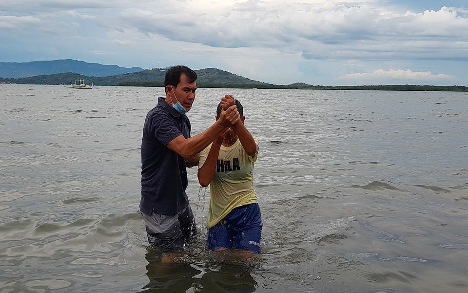 Dennis Bello supervising baptism rites