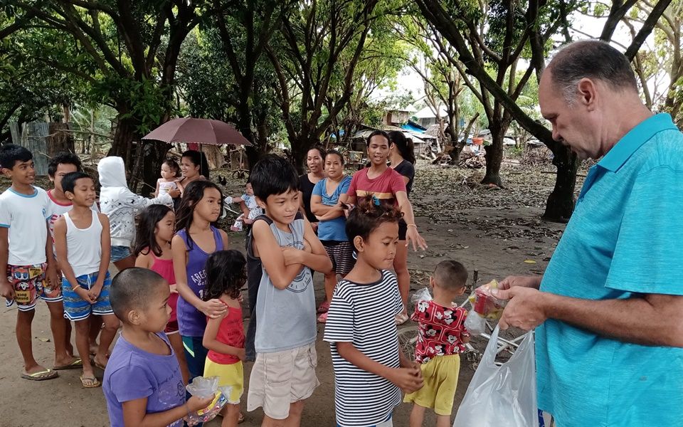 CEA Director Ron Brown distributing food packs - December 2021