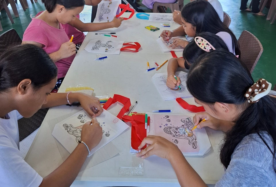 CEA children doing an arts and crafts activity Summer 2025