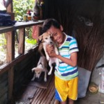 Boy with puppies at Sitio Kasagingan Tanjay City