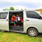 The children happily posing inside their own service vehicle. The children happily posing inside their own service vehicle